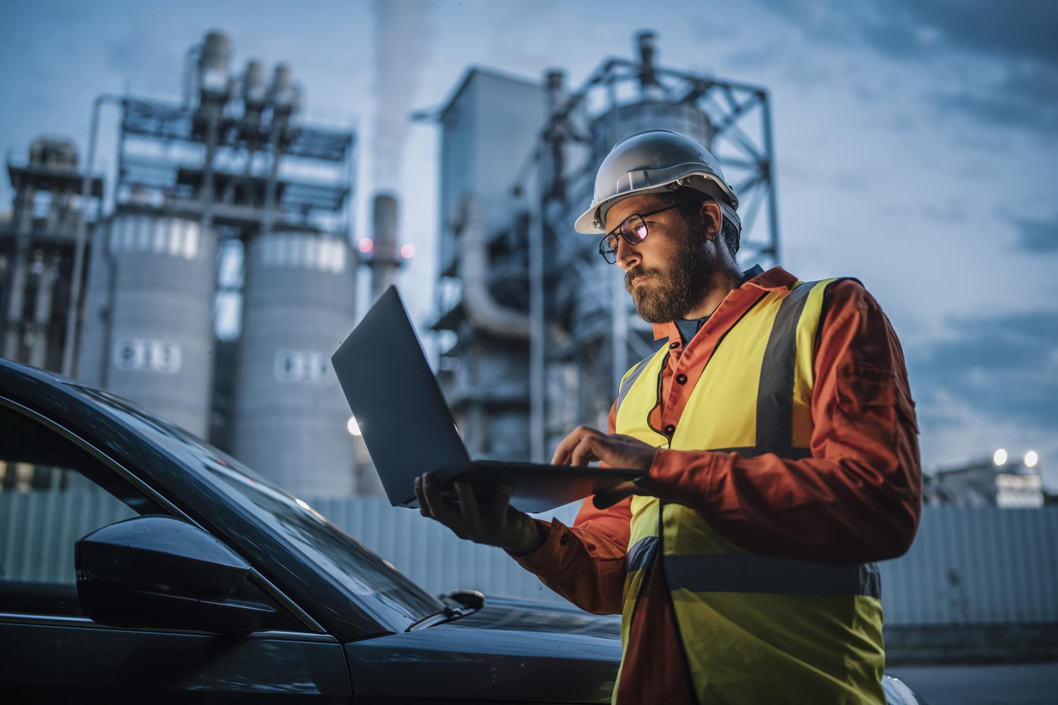 pumps-in-oil-and-gas-industry-worker-looking-at-laptop